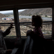 Central American children who are traveling with a caravan of migrants, look at the border wall from a bus carrying the group to a gathering of migrants living on both sides of the border, in Tijuana, Mexico, Sunday, April 29, 2018.